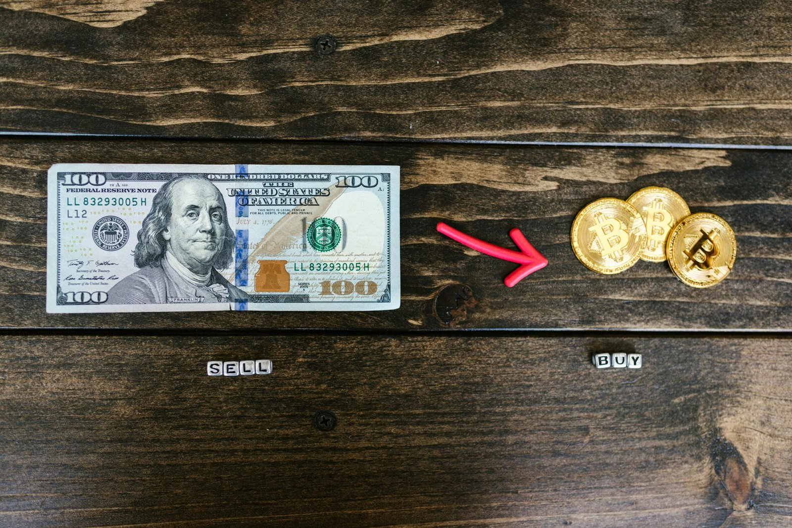Home Bitcoin coins and a dollar bill symbolize digital and traditional currency trade.